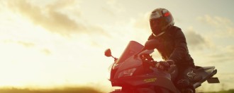 Frame from our Honda CBR motorcycle commercial - Directed by Joel Black and shot on the Red Helium 8K and Xeen Cinema Lenses Video Production - Honda CBR600 riding along a country road on sunset