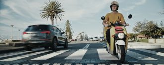 Susuru Delivery scooter with Audi passing